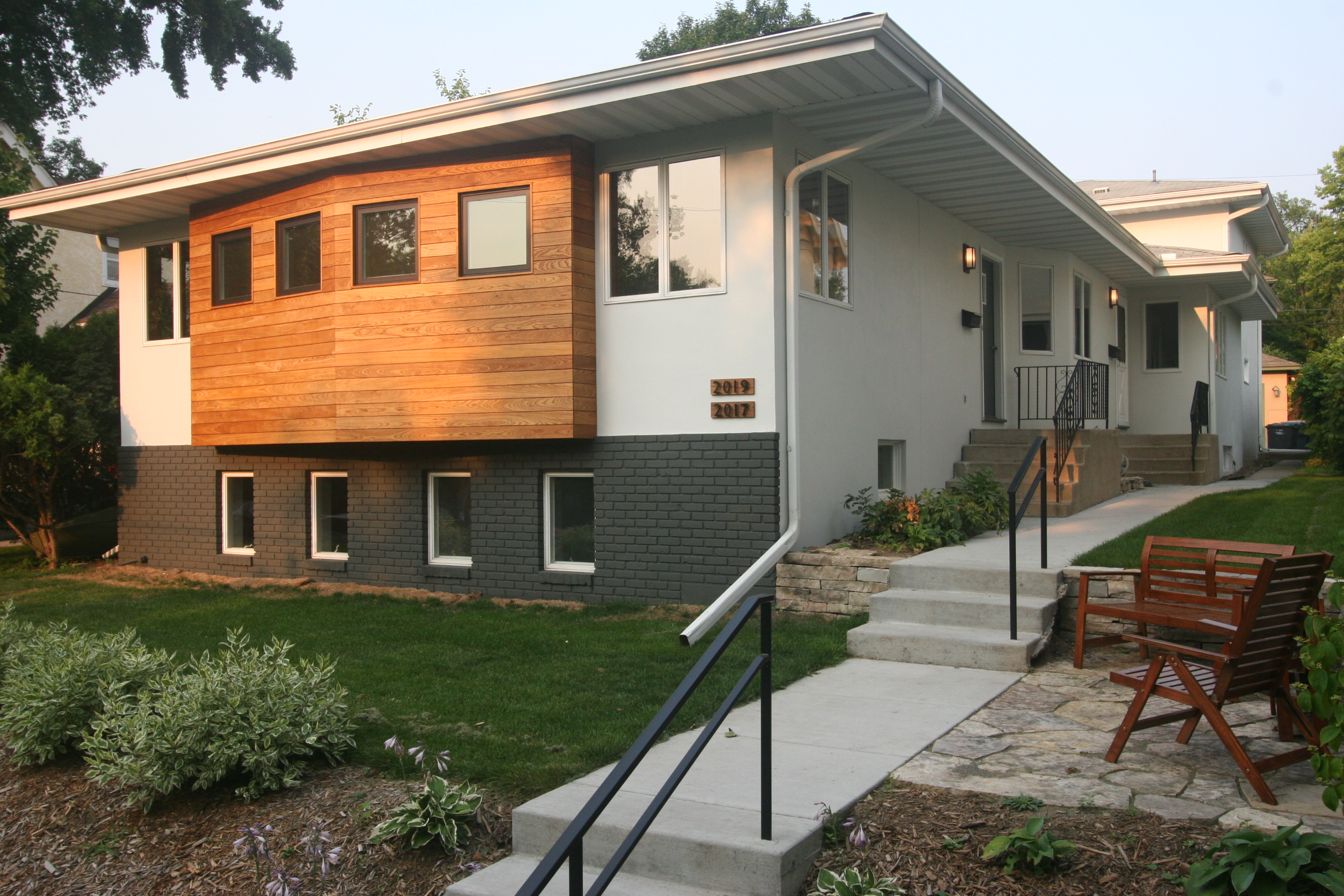 image of duplex exterior. Image showcases front of house and two entrances- one to each unit.
