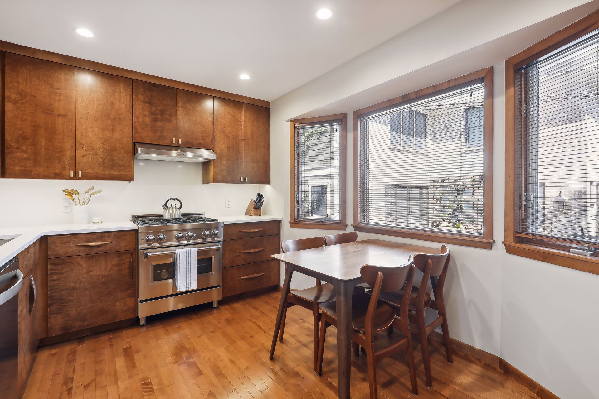 image of kitchen featuring eat-in dining for 4 and professional range.